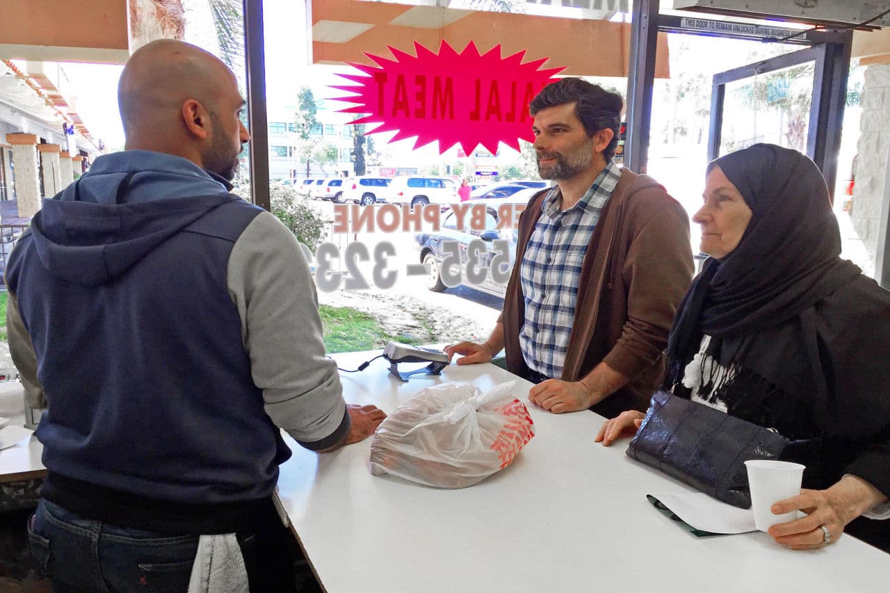 Majd Takriti, center, and his mother, name not given, visiting from Lebanon, pick up Halal meat at a butcher shop in Orange County's "Little Arabia" neighborhood just miles from Disneyland, Wednesday, March 23, 2016. (AP Photo/Gillian Flaccus)