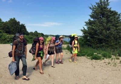 Members of the Massachusetts Walking Tour prepare to wade across a shallow tidal stream on the South Coast Bikeway in Mattapoisett. Left to right: Mark Mandeville, Amy Alvey, Raianne Richards, Kristen Sykes and Mark Kilianski. (Courtesy)