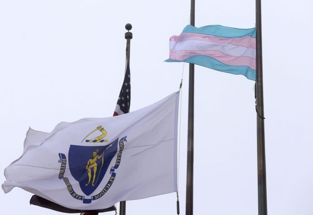 In this Monday, May 2, 2016 photo, a flag representing the transgender community, foreground, flies next to the Massachusetts state flag and a U.S. flag in front of Boston City Hall. Boston Mayor Marty Walsh, a supporter of transgender rights, said the flag will continue to fly until everyone is equal under the law in Massachusetts. (AP Photo/Steven Senne)