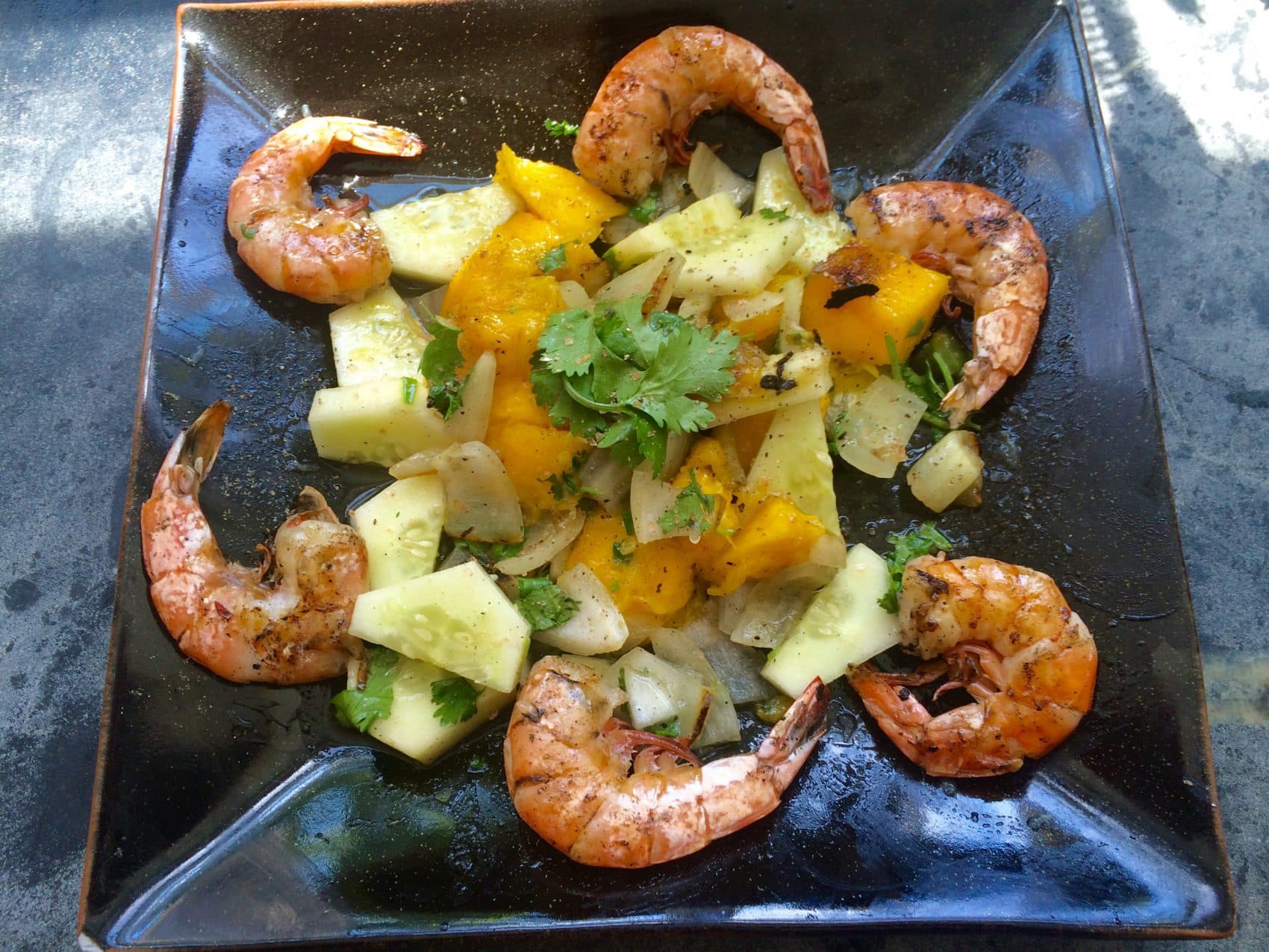 Kathy's spicy grilled mango and cucumber salad with grilled shrimp. (Kathy Gunst for Here &amp; Now)