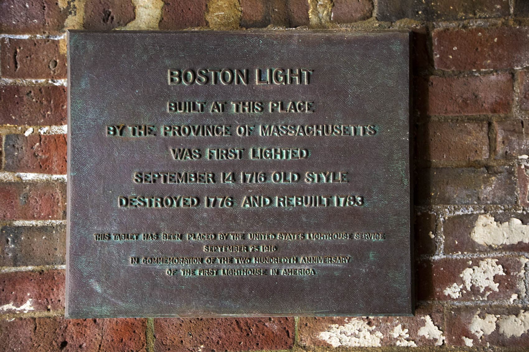 Plaque indicating when the original lighthouse was erected, destroyed and then rebuilt. (Jesse Costa/WBUR)