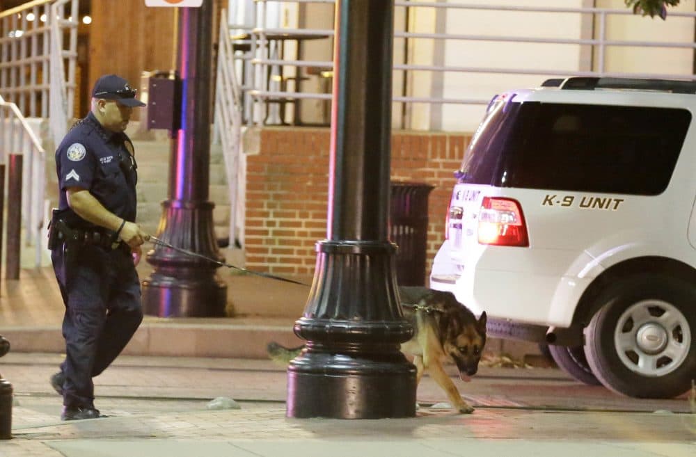 Law enforcement sweeps the area for explosives after a shooting in downtown Dallas early Friday. (LM Otero/AP)