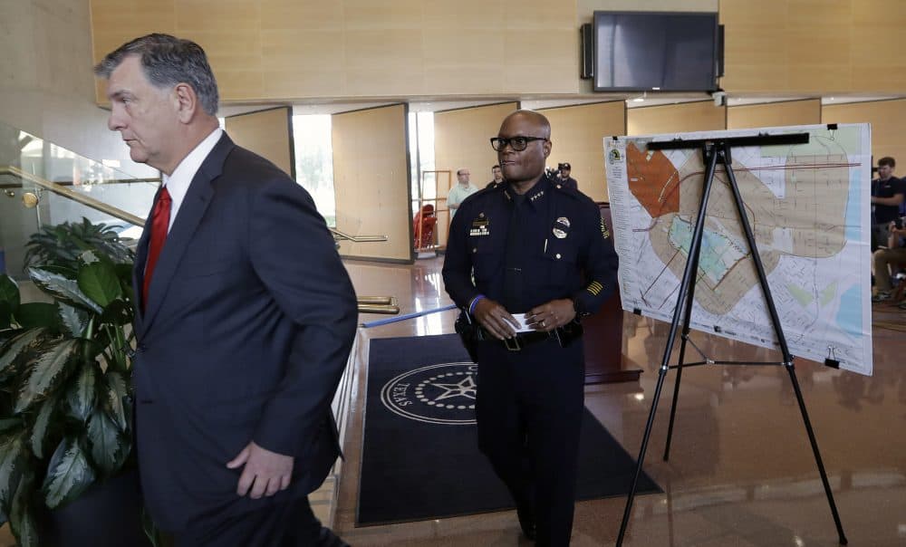 Dallas Mayor Mike Rawlings, left, and Dallas Police Chief David Brown, right, leave a news conference on Friday in Dallas after giving members of the press updates. (Eric Gay/AP)