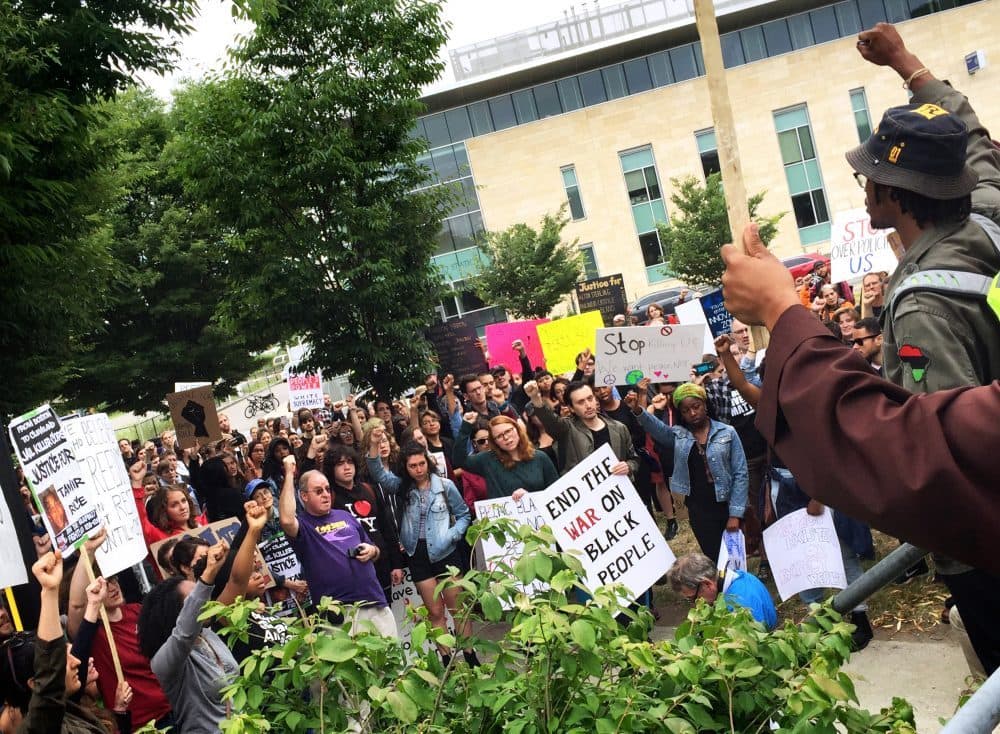 Demonstrators gathered outside the Roxbury Innovation Center on Saturday, June 9, 2016. (Jack Lepiarz/WBUR)