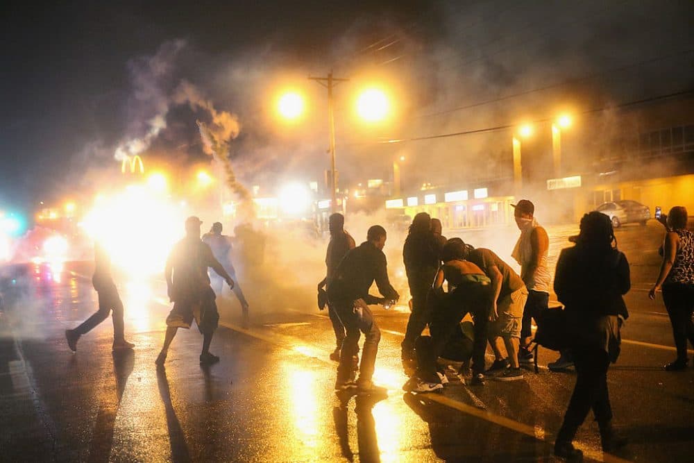 Police fire tear gas at demonstrators protesting the shooting of Michael Brown after they refused to honor the midnight curfew on August 17, 2014 in Ferguson, Missouri. (Scott Olson/Getty Images)