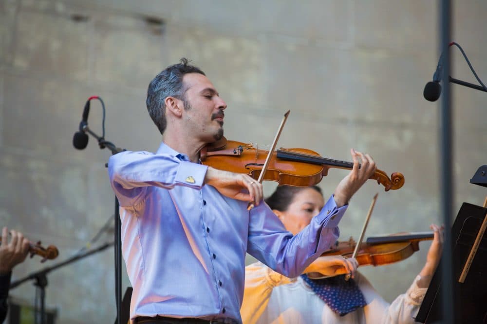 Violinist and co-founder Colin Jacobsen performs with The Knights in Central Park. (Courtesy of Noah Stern Weber/The Knights