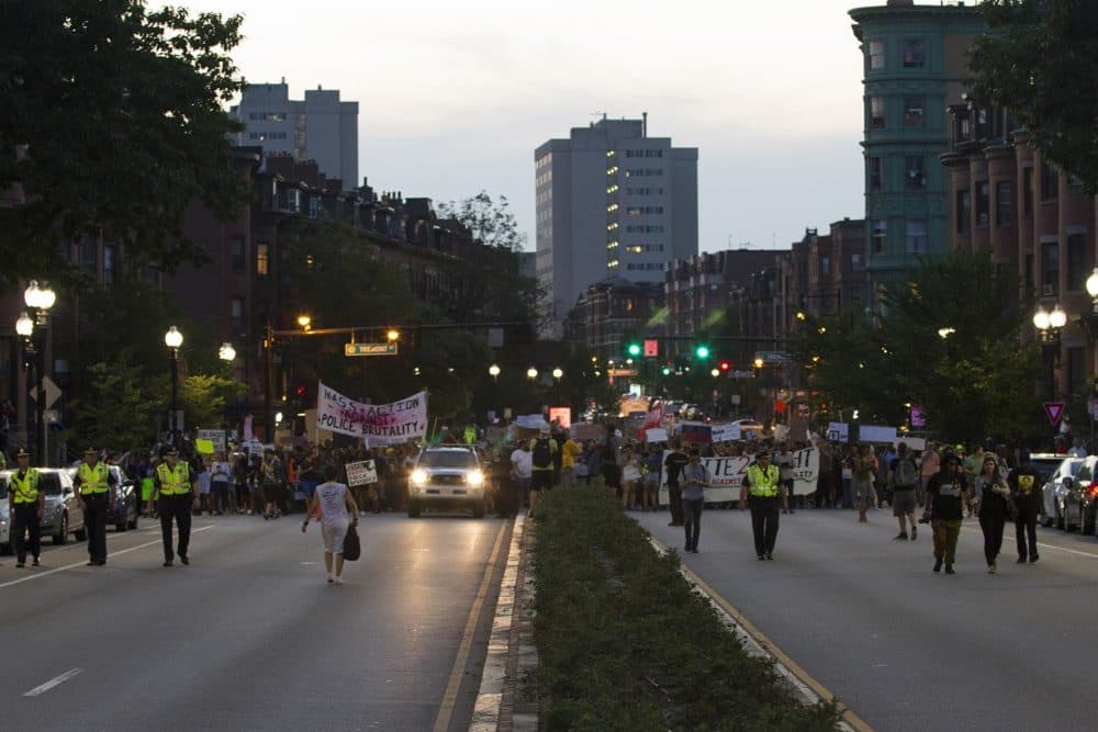 The demonstrators temporarily shut down Massachusetts Avenue as they wound their way to Dudley Station in the city's Roxbury neighborhood. (Joe Difazio for WBUR)
