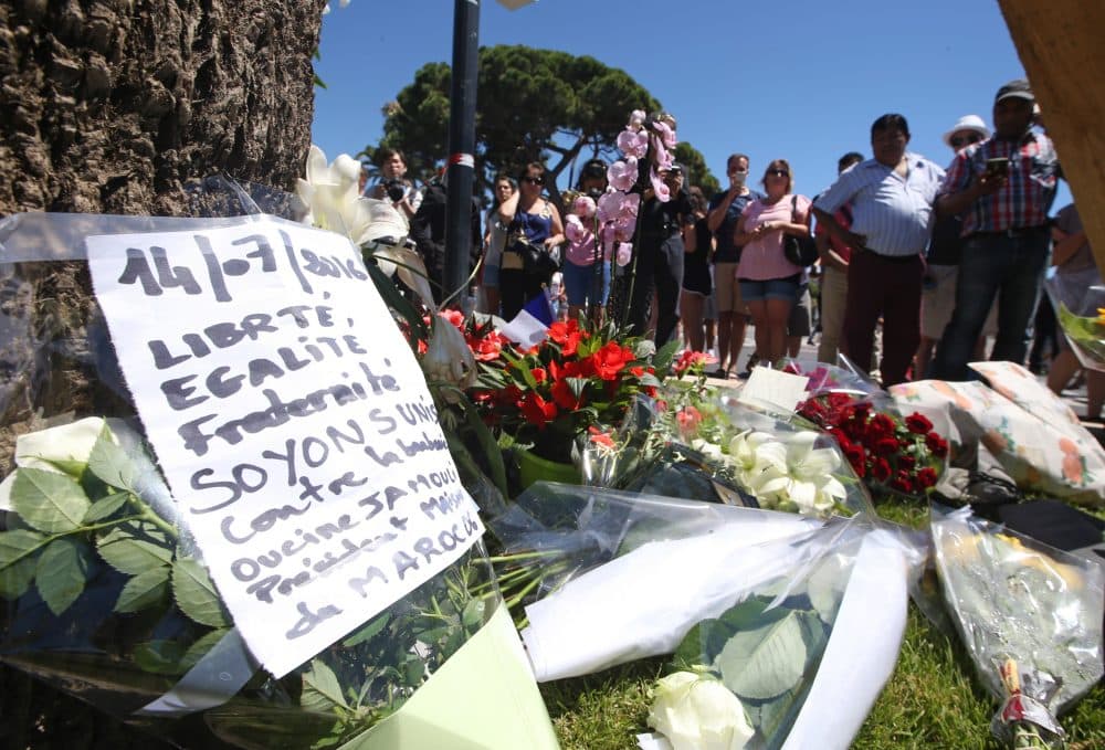 Floral tributes are laid out near the site of the truck attack in the French resort city of Nice, southern France, Friday, July 15, 2016. France has been stunned again after a large white truck killed many people after it mowed through a crowd of revellers gathered for a Bastille Day fireworks display in the Riviera city of Nice. (AP Photo/Luca Bruno)