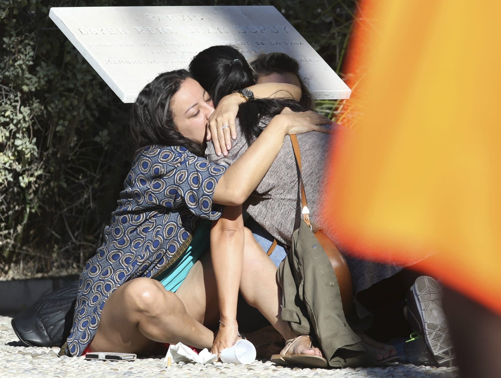Parents of victims embrace each other near the scene of a truck attack  in Nice, southern France, Friday, July 15, 2016. A large truck mowed through revelers gathered for Bastille Day fireworks in Nice, killing more than 80 people and sending people fleeing into the sea as it bore down for more than a mile along the Riviera city's famed waterfront promenade. (Luca Bruno/AP)