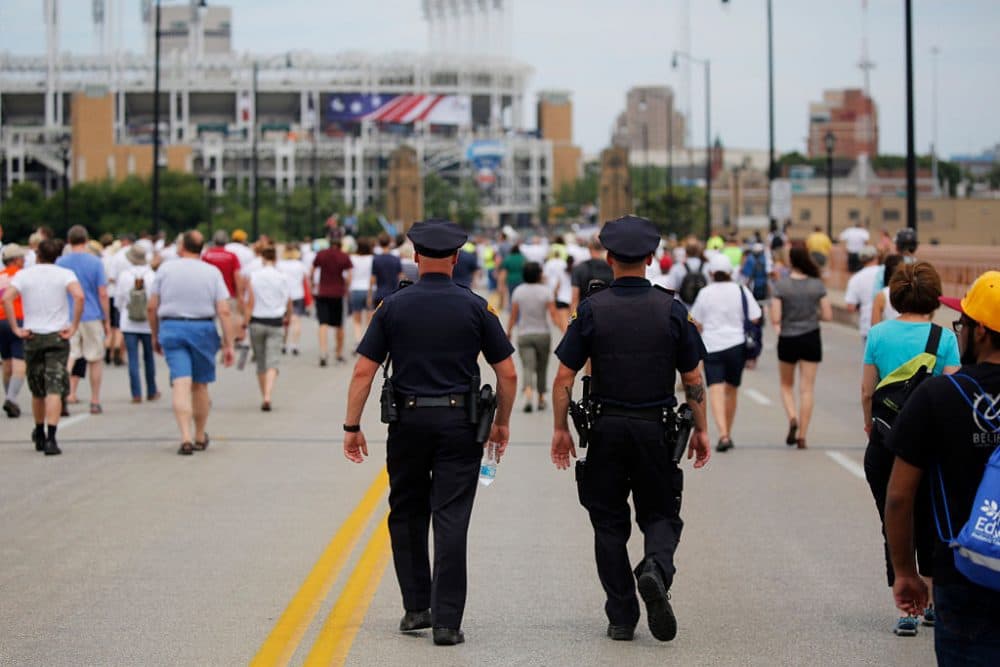 Police officers walk among people marching to join hands in a peace rally amid preparations for the arrival of visitors and delegates for the Republican National Convention on July 17, 2016, in Cleveland, Ohio. (Dominick Reuter/AFP/Getty Images)
