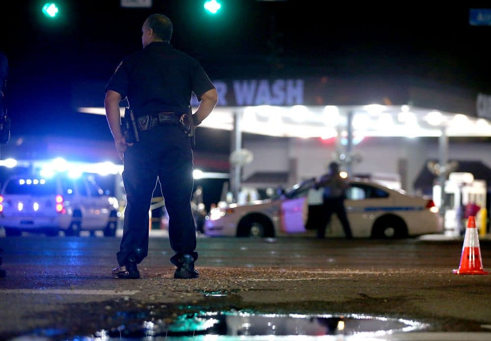 Police officers stand near the scene of where three police officers were killed on July 17, 2016 in Baton Rouge, Louisiana. The suspect, identified as Gavin Long of Kansas City, is dead after killing three police officers and injuring three more. (Sean Gardner/Getty Images)