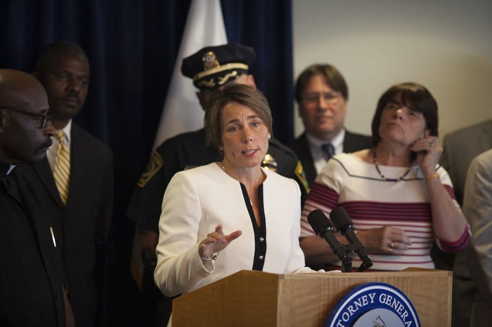 Surrounded by police, district attorneys and clergy, state Attorney General Maura Healey on Wednesday announces new enforcement of Massachusetts’ assault weapon ban. (Joe Difazio for WBUR)