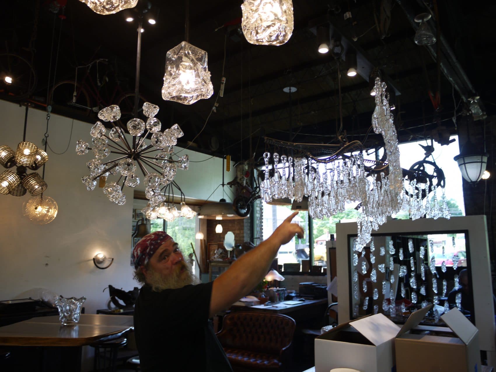 Cleveland Art manager Bart Hanick shows chandeliers to Here &amp; Now producer Alex Ashlock. (Alex Ashlock/Here &amp; Now)