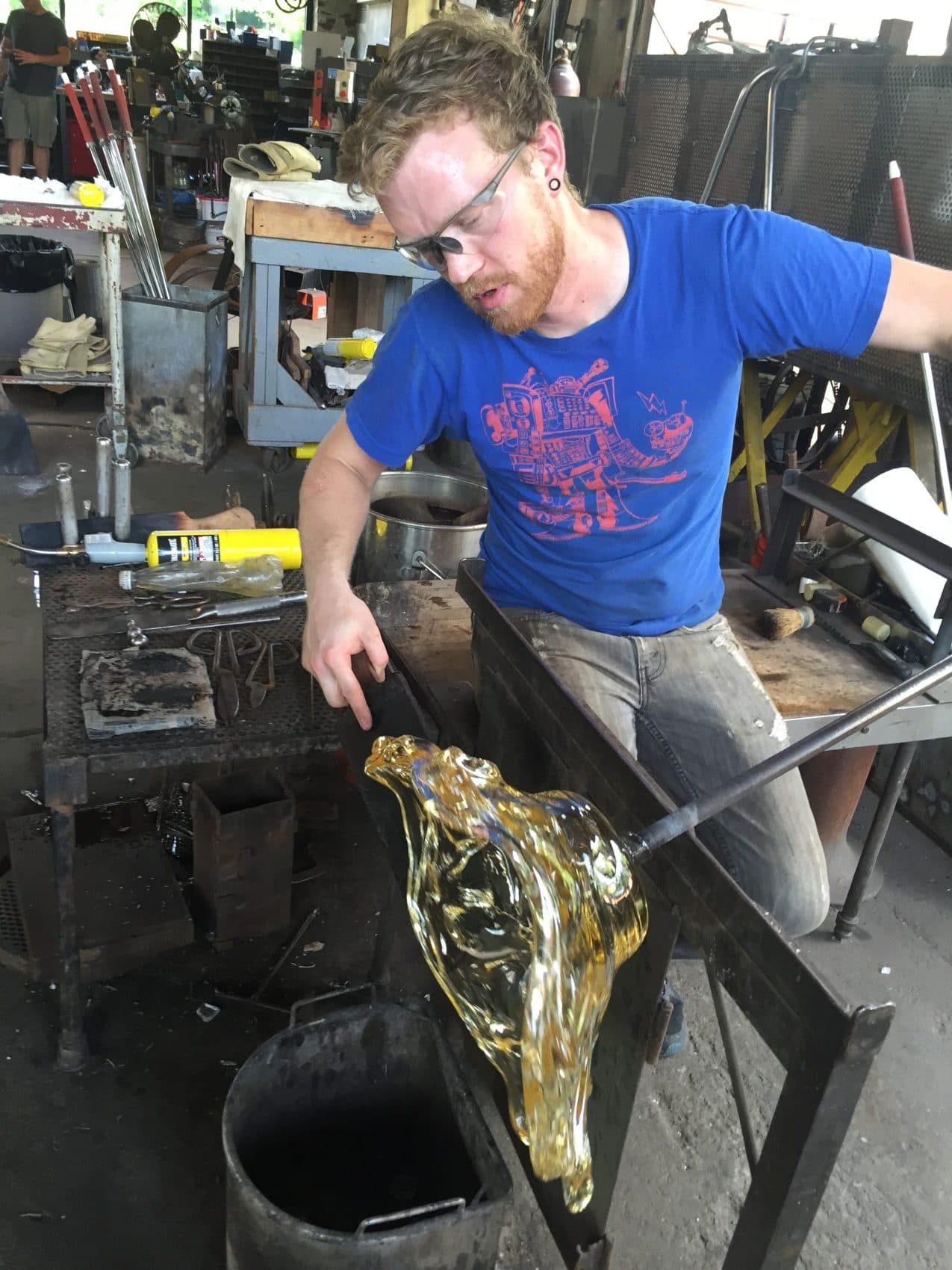 Glassblower Chris Adamick works on a new piece in the Cleveland Art studio. (Robin Young/Here &amp; Now)
