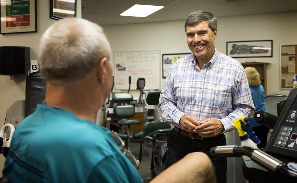 Westcott talks with chef Kevin Colby at the Quincy College gym. (Robin Lubbock/WBUR)