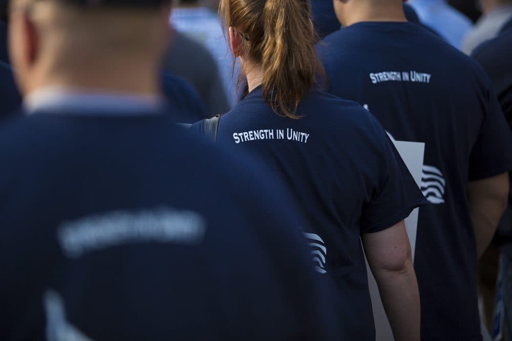 Officers at the rally wore T-shirts with the words &quot;Strength In Unity&quot; on the back. (Jesse Costa/WBUR)