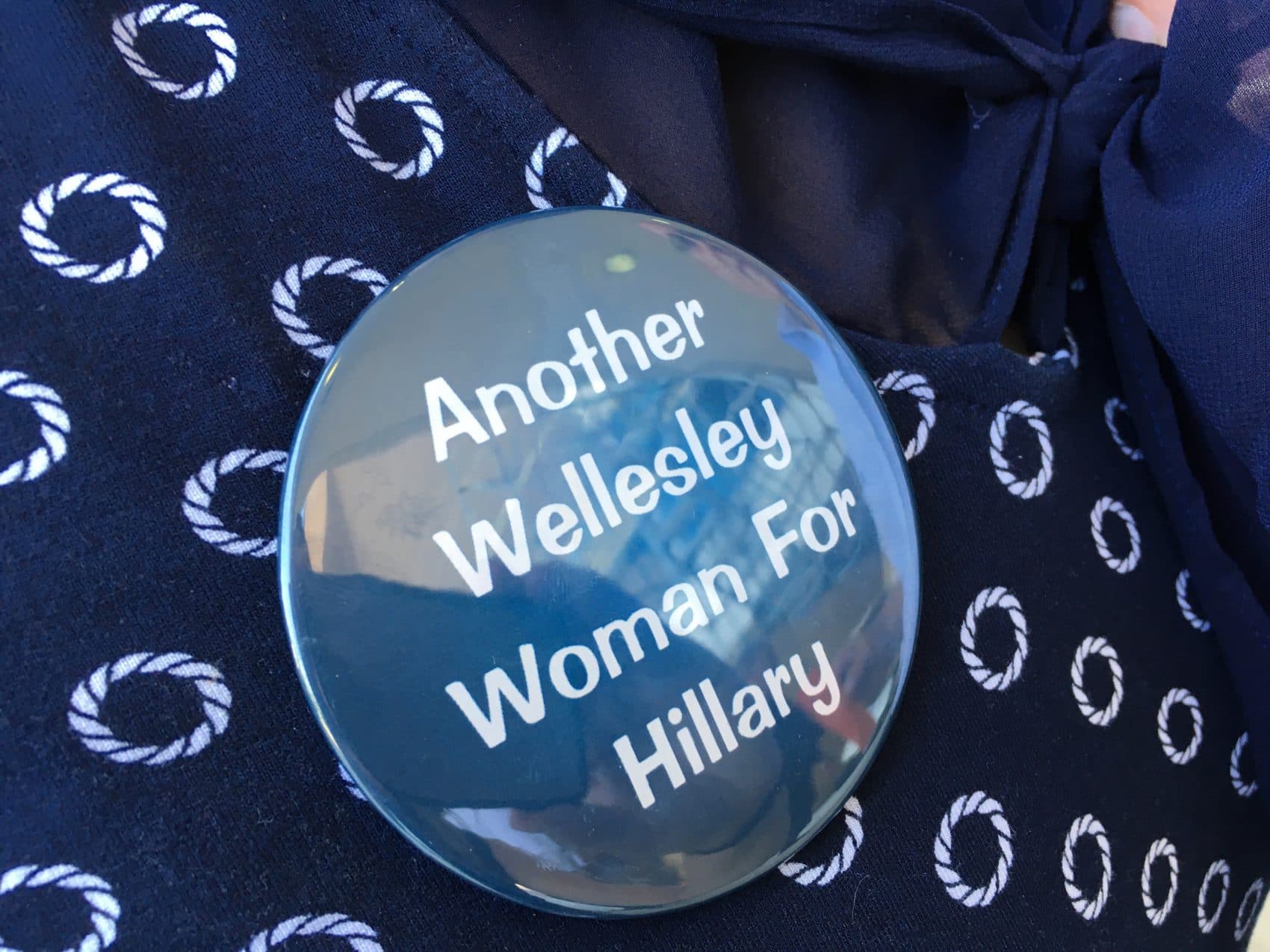 A &quot;Another Wellesley Woman For Hillary&quot; button, pinned to Suzanne Salomon's shirt. Salomon was Clinton's suitemate at the college for three years. (Samantha Fields/Here &amp; Now)