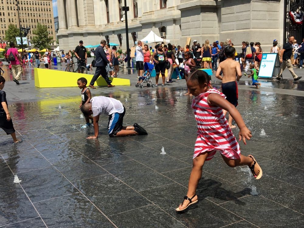 Six-year-old Quadarah Brown plays in the public fountain in front of Philadelphia City Hall. (Shannon Dooling/WBUR)