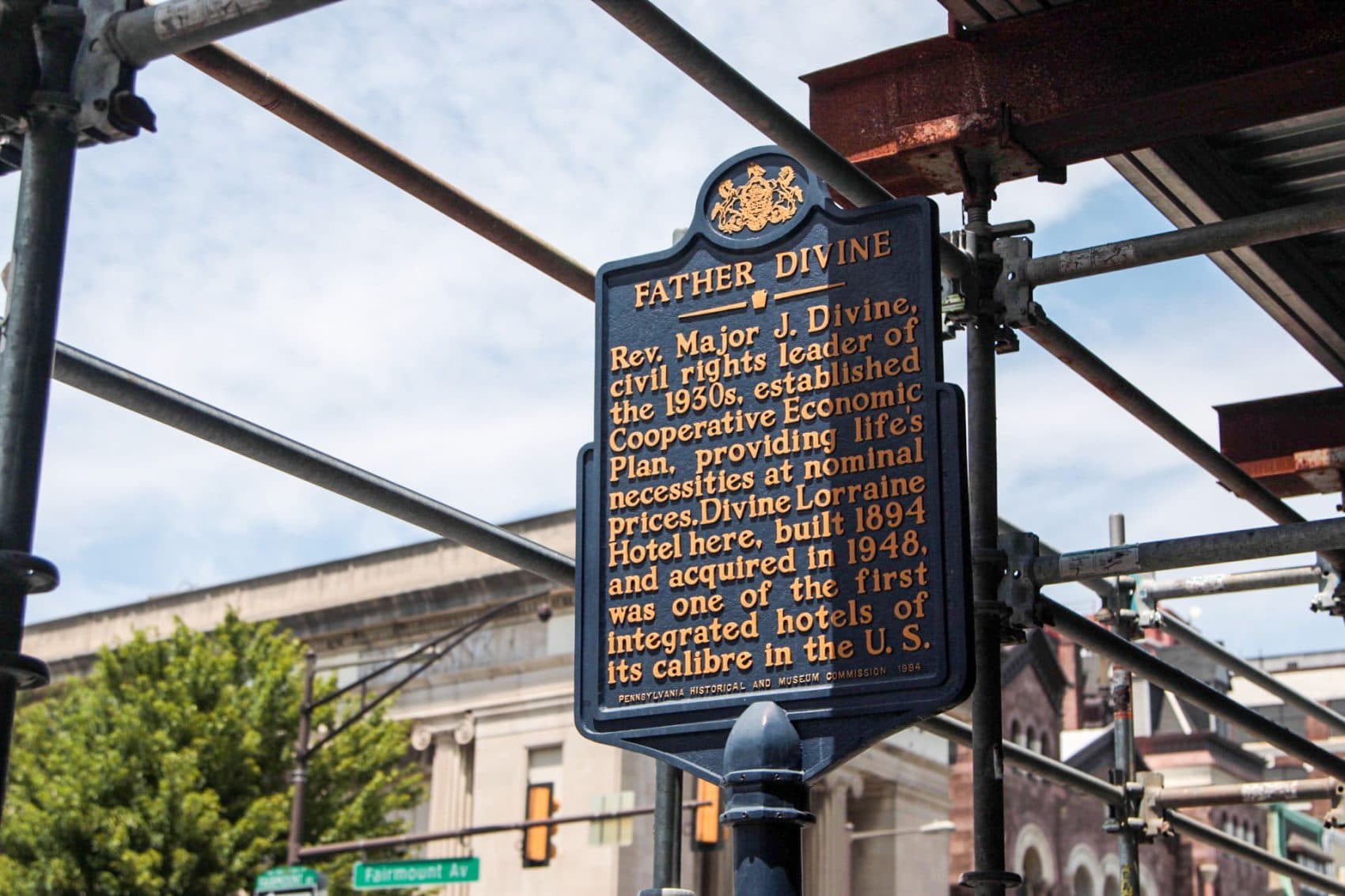 Outside of the Divine Lorraine Hotel, sign is posted about Father Divine, a spiritual leader and former owner of the hotel. (Dean Russell/Here &amp; Now)