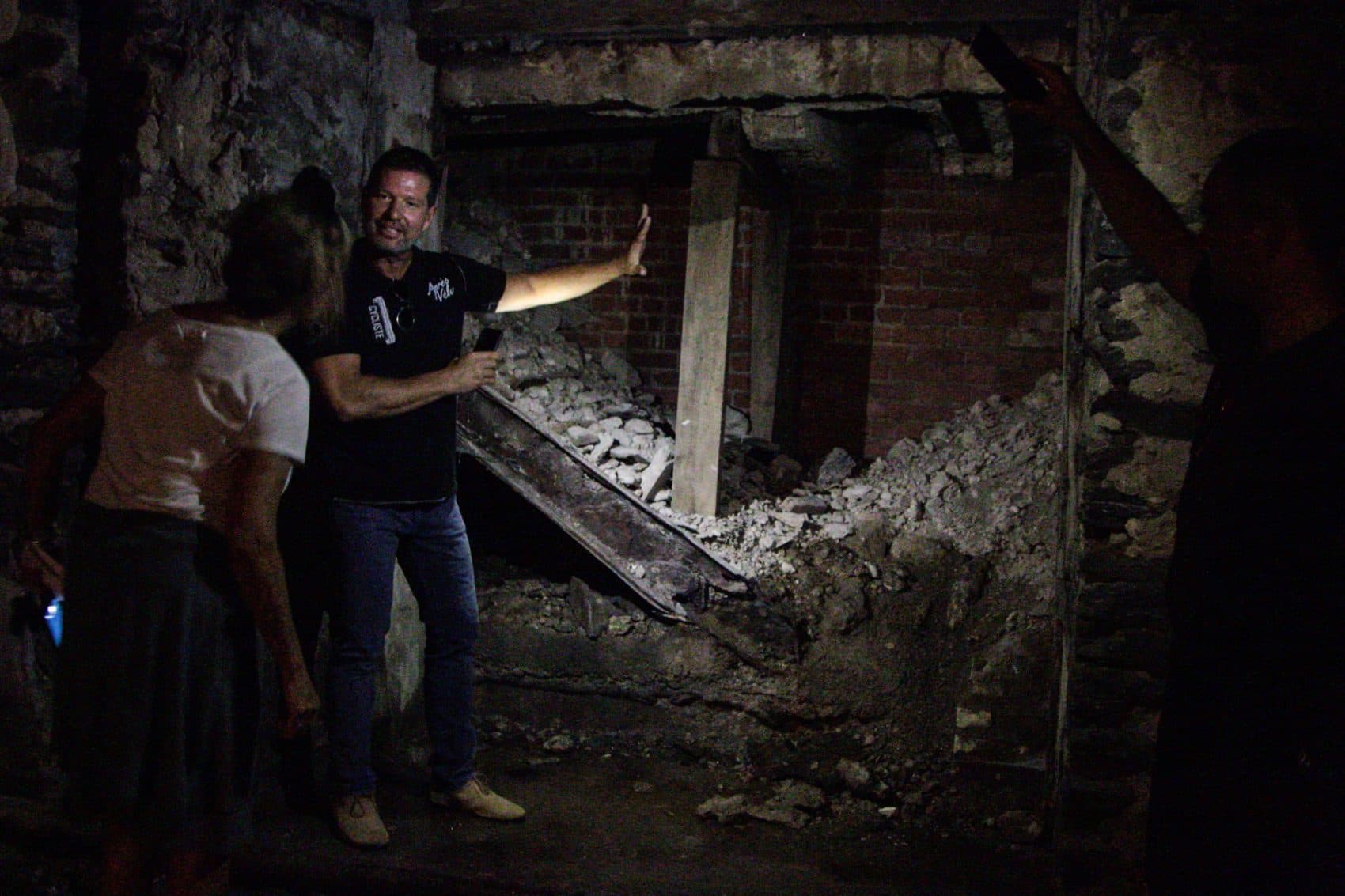 Eric Blumenthal, developer and owner of the Divine Lorraine Hotel building, shows Here &amp; Now's Robin Young the basement level which includes an old entrance to a Prohibition era speakeasy. (Dean Russell/Here &amp; Now)