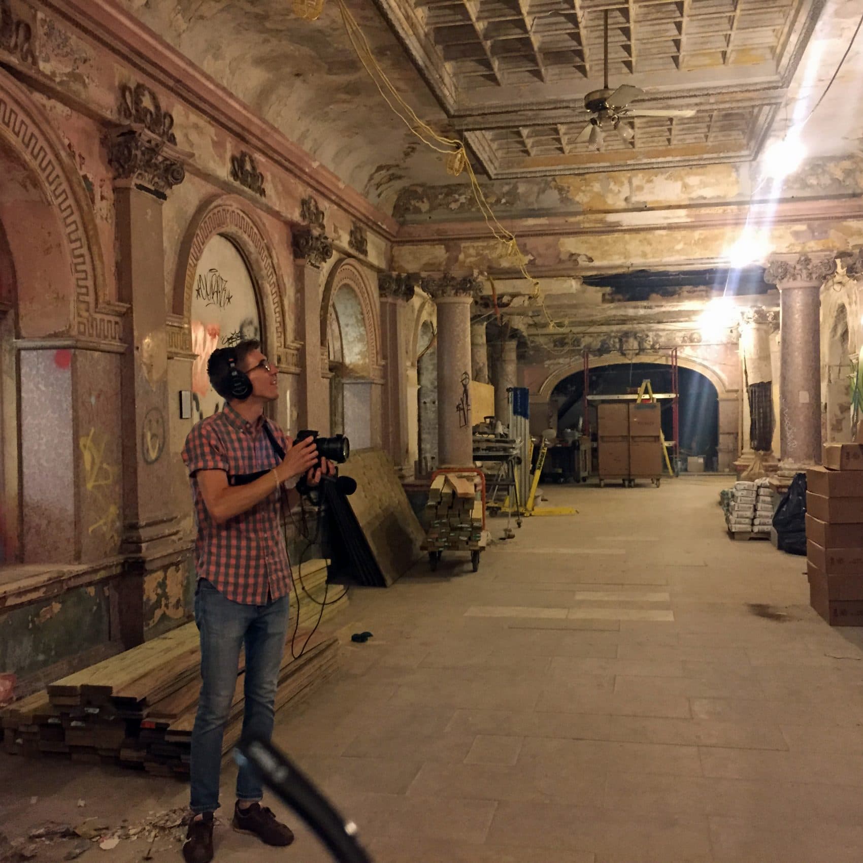 Here &amp; Now producer Dean Russell stands in the first floor of the Divine Lorraine Hotel in North Philadelphia. (Robin Young/Here &amp; Now)