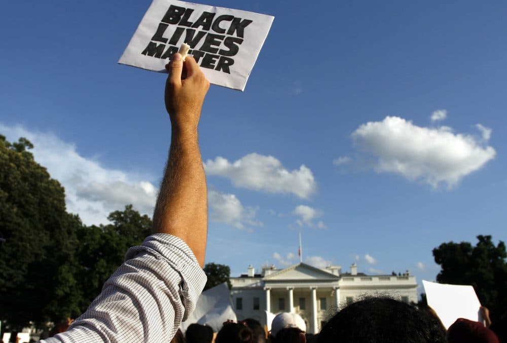 Protesters stand outside of the White House protesting police brutality on Friday, July 8, 2016, in Washington (Sarah Grace Taylor/AP)