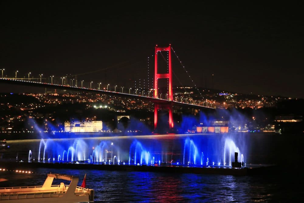 Istanbul's iconic Bosporus Bridge is lit in the colors of the French flag on Friday in solidarity with the victims of Thursday's attack in Nice. (Lefteris Pitarakis/AP)