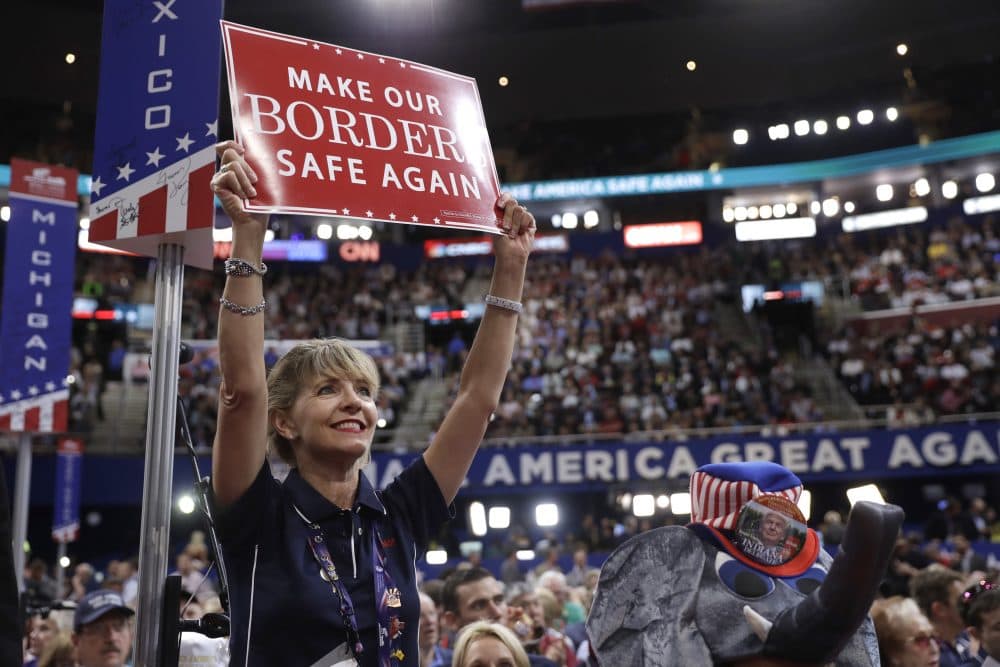 New Mexico delegate Susan Throckmorton holds up a sign during the first day of the Republican National Convention. (Matt Rourke/AP)