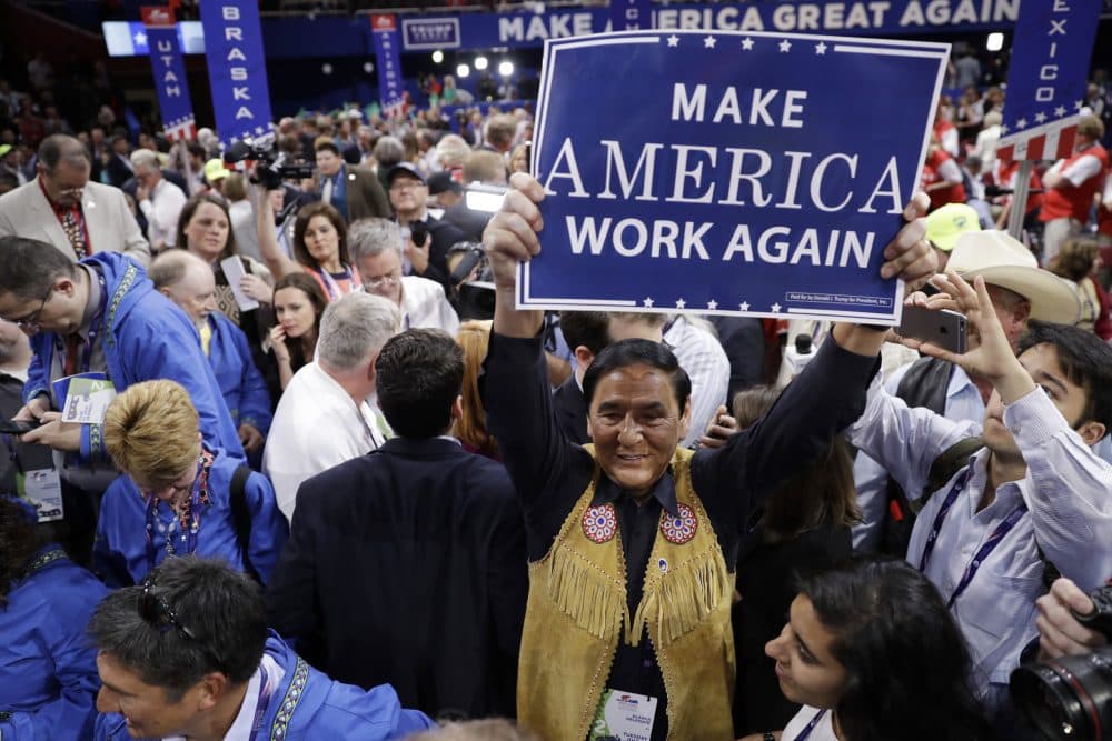Alaska delegate Jerry Ward holds up a sign with the theme of the night on it. (Matt Rourke/AP)