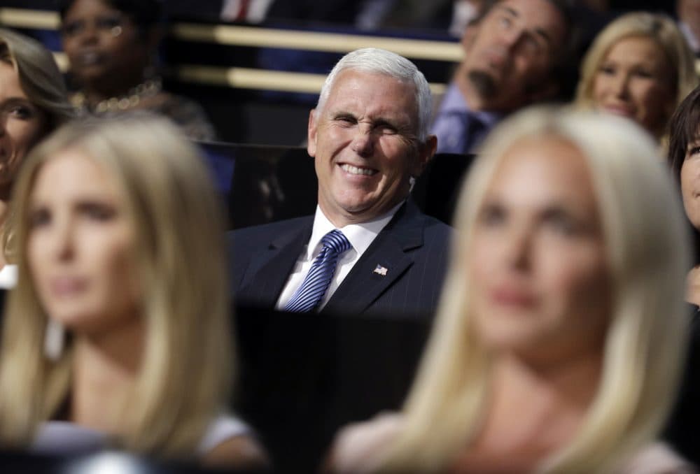 Vice presidential nominee Gov. Mike Pence of Indiana smiles as he sits during the second day of the Republican National Convention. (John Locher/AP)