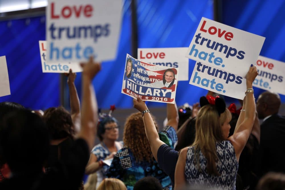 Delegates hold up signs during the first day of the Democratic National Convention in Philadelphia Monday. (Carolyn Kaster/AP)