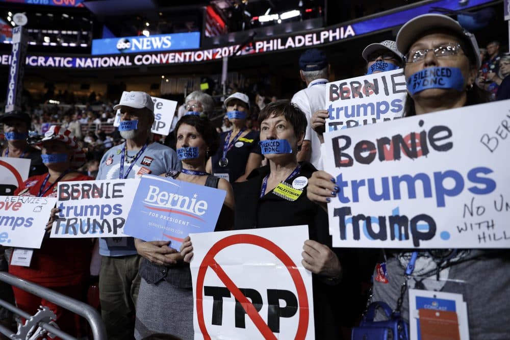Michigan delegates who support Bernie Sanders wear tape covering their mouths that reads, &quot;Silenced by DNC.&quot; (John Locher/AP)