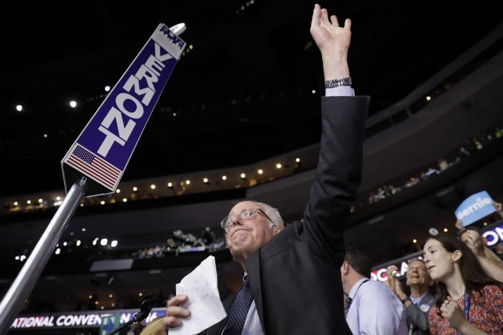 Sen. Bernie Sanders waves before asking that Hillary Clinton become the unanimous choice for the Democratic nominee for president. (Matt Rourke/AP)