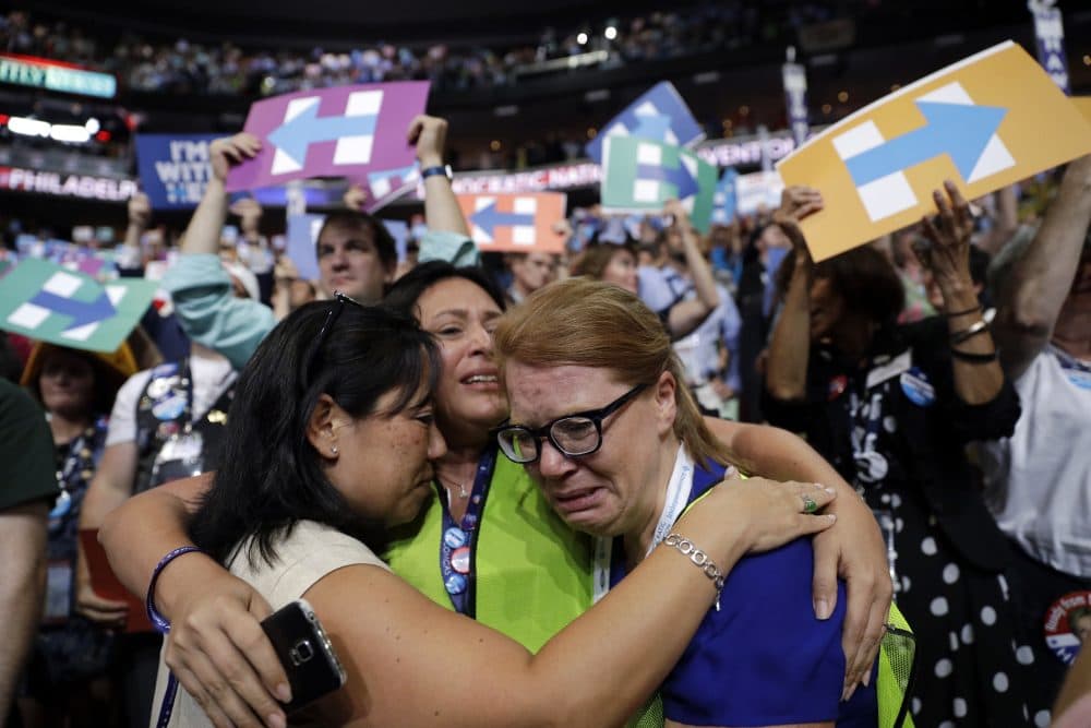 Carrie Pugh, left, Katrina Mendiola and Mayors Wegmann cry as Hillary Clinton officially becomes the first woman to be the presidential nominee of a major U.S. political party. (John Locher/AP)