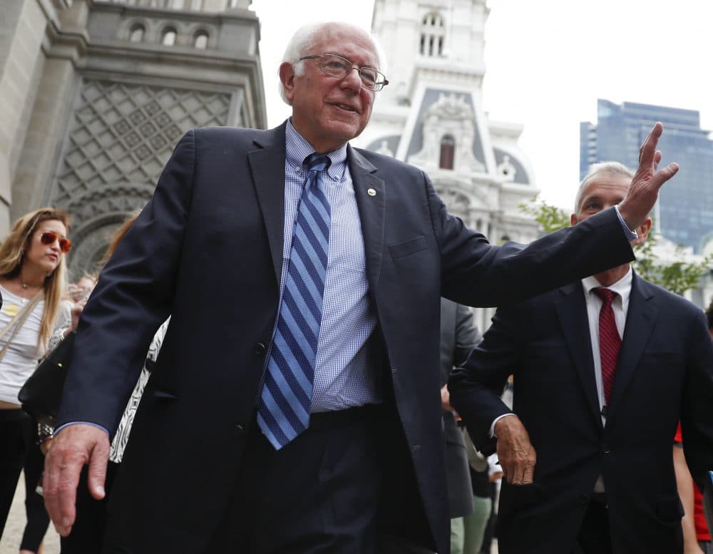 Sen. Bernie Sanders waves to a supporter in downtown Philadelphia on Thursday, during the final day of the Democratic National Convention. (John Minchillo/AP)