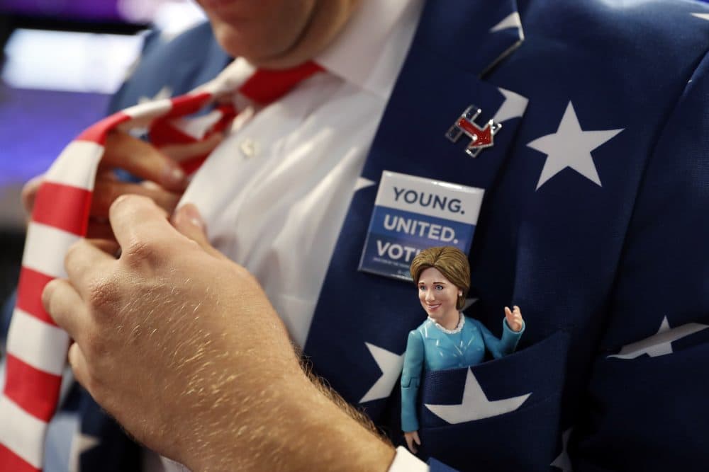 Virginia delegate Morgan Jameson puts on a tie as he shows off a Hillary Clinton doll on his chest pocket on his jacket as he arrives at Wells Fargo Arena before the start of the final day of the Democratic National Convention in Philadelphia on Thursday. (Carolyn Kaster/AP)