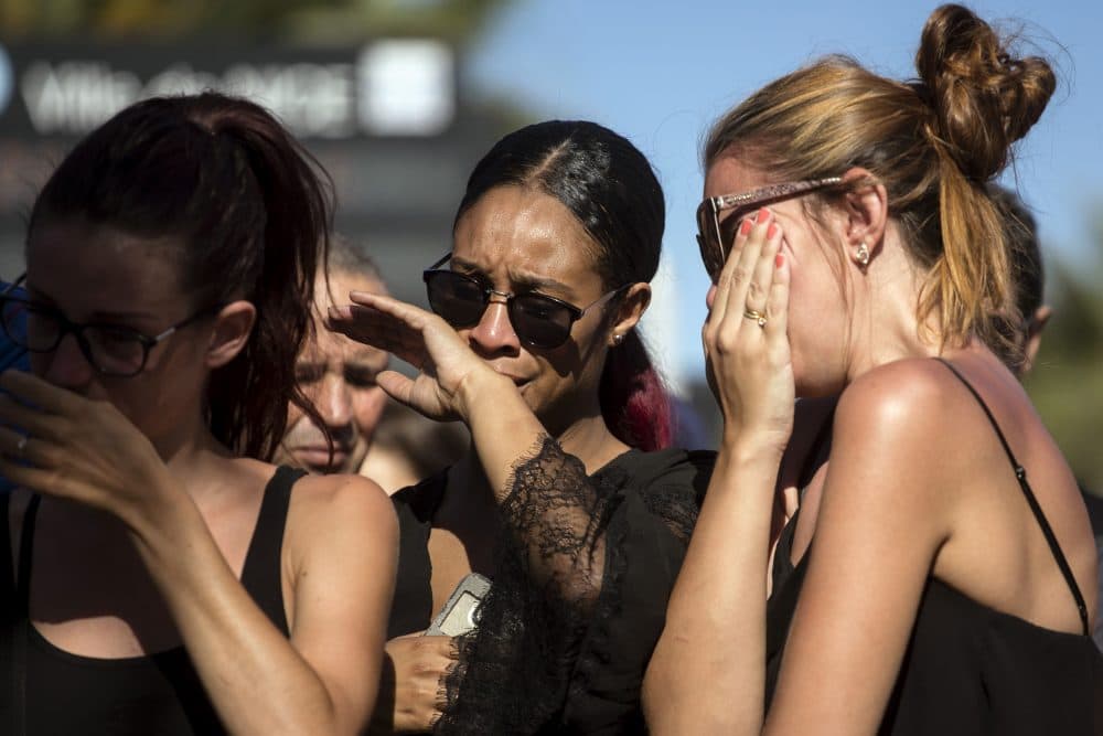 Women react near the scene of an attack where a truck mowed through revelers in Nice. (Laurent Cipriani/AP)
