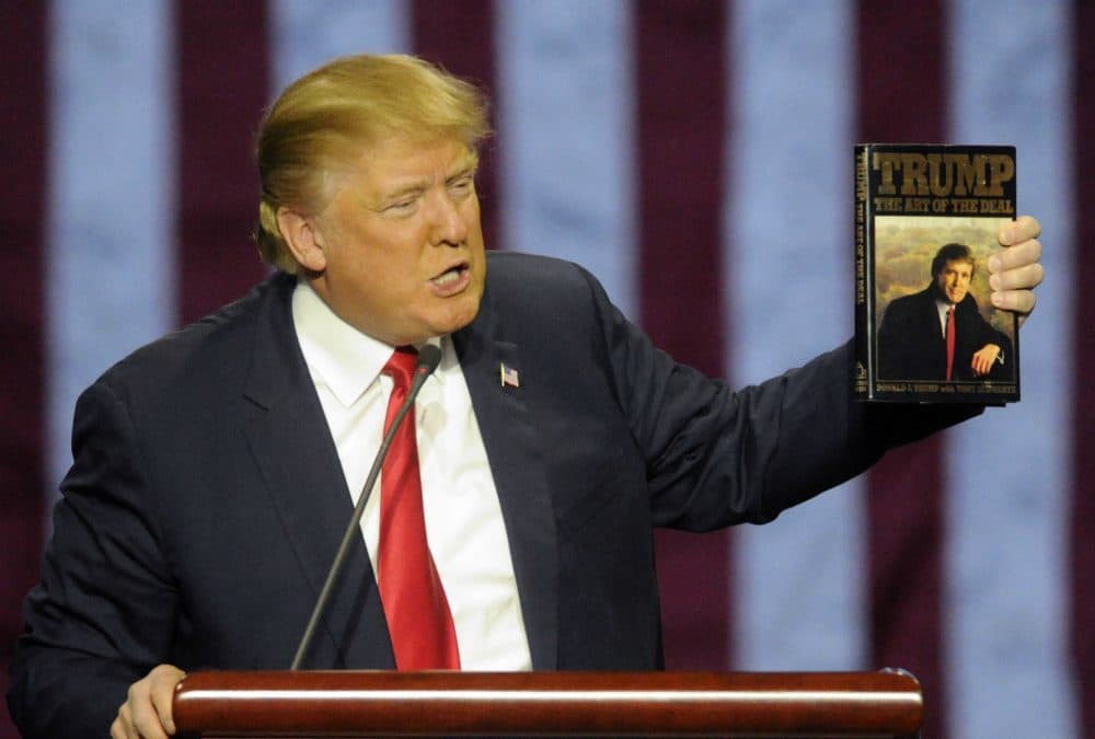 Republican presidential candidate Donald Trump holds up his book &quot;The Art of the Deal,&quot; as he speaks during a campaign stop Saturday, Nov. 21, 2015 in Birmingham, Ala. (Eric Schultz/AP)