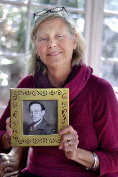 Kris Fayerman-Piatt holds a picture of her father, Severin Fayerman, before he came to America. (Michelle O’Berg Figueroa for WBUR)