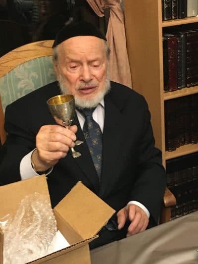 Sidney Schlesinger in his home in Brooklyn, upon receiving the Kiddush cup that belonged to his grandfather and father, who both perished in the Holocaust. (Courtesy)