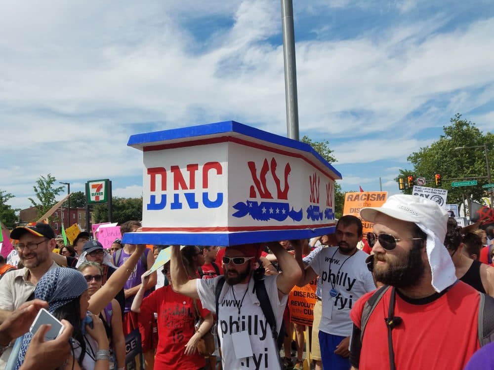 Protesters carry a makeshift casket symbolically representing the Democratic National Convention at a Black Lives Matter protest on Tuesday. (Zeninjor Enwemeka/WBUR)