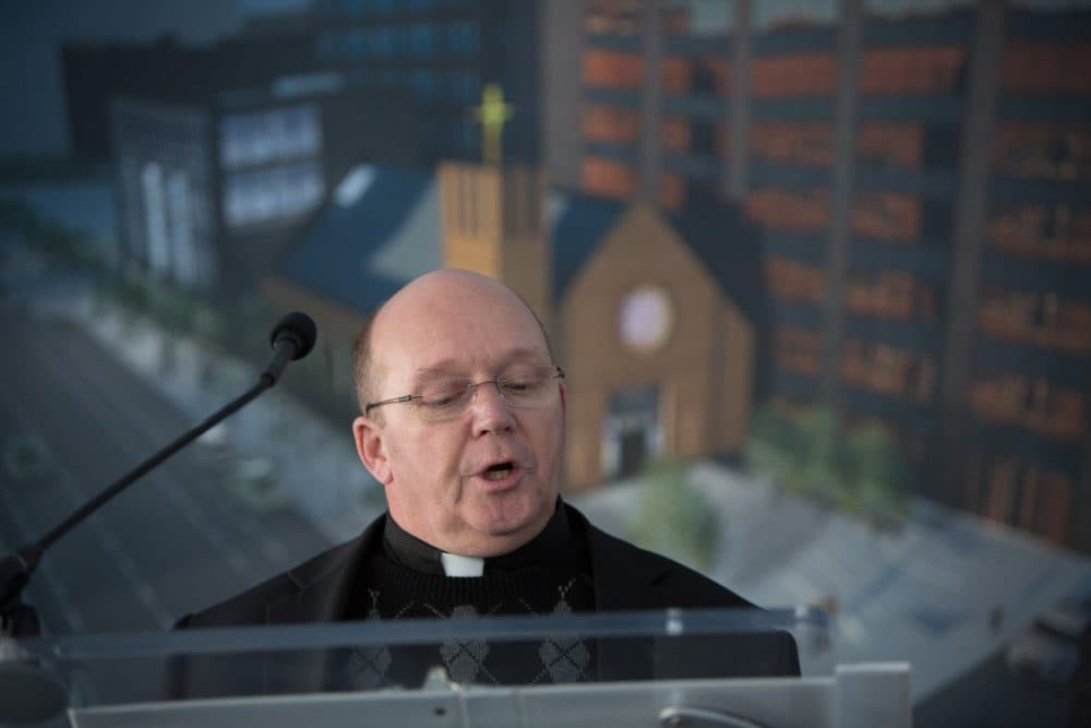 Rev. Joe White, pastor of St. Vince de Paul and Our Lady of Good Voyage, speaks in November, 2014 at the groundbreaking for the new Our Lady of Good Voyage Chapel, pictured behind him. (Roman Catholic Archdiocese of Boston/Flickr)