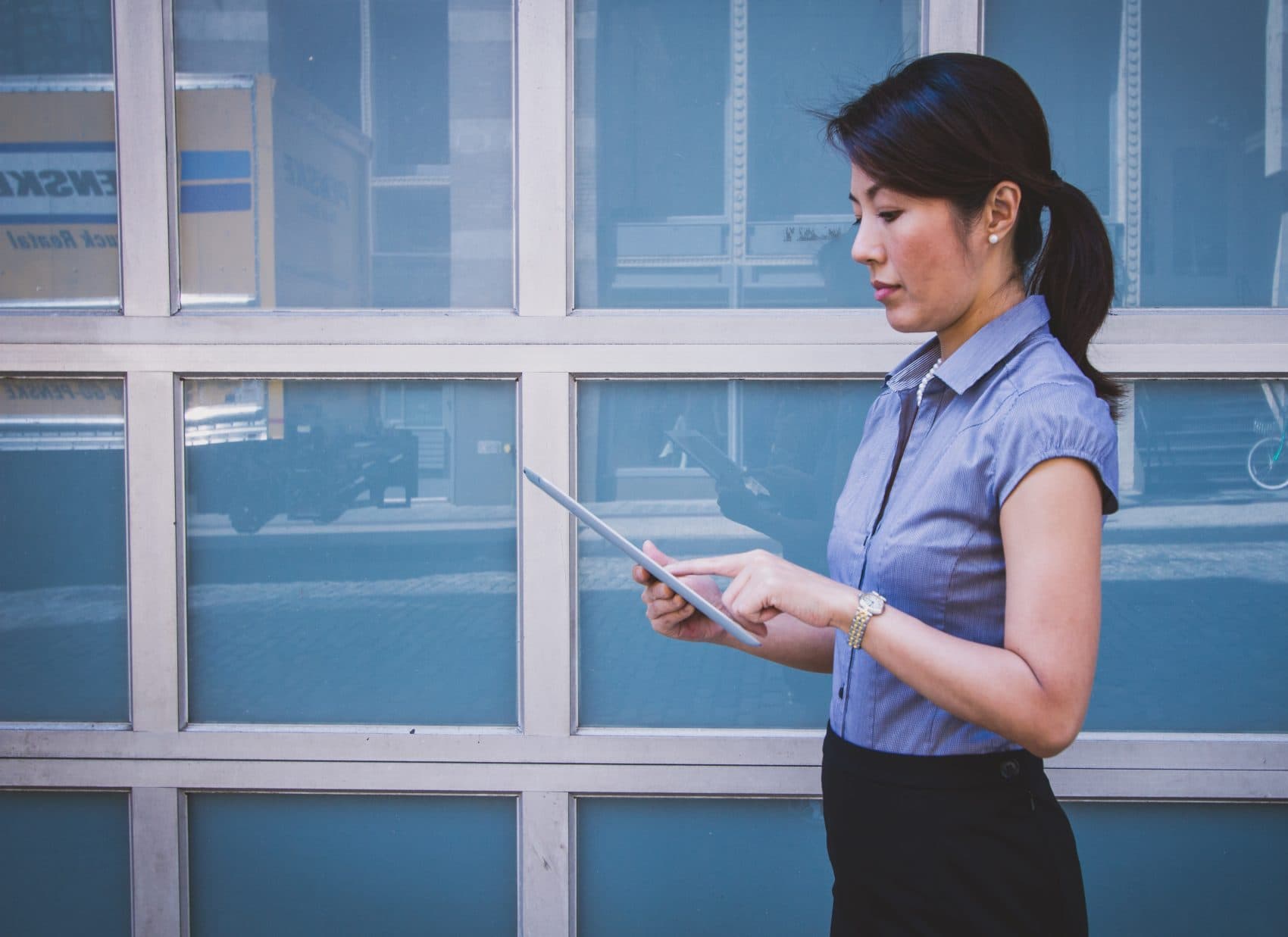 A woman working on a tablet. (Benjamin Child/Unsplash)