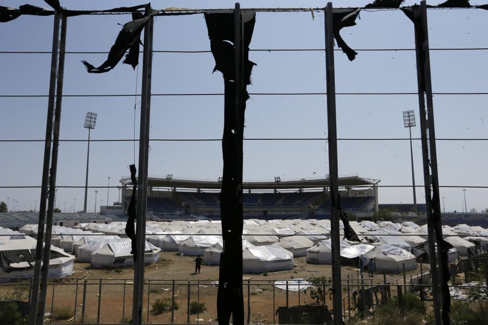 The baseball venue at the Hellinikon Olympic Complex is now used as a shelter for almost 1,000 people. (Thanassis Stavrakis/AP)