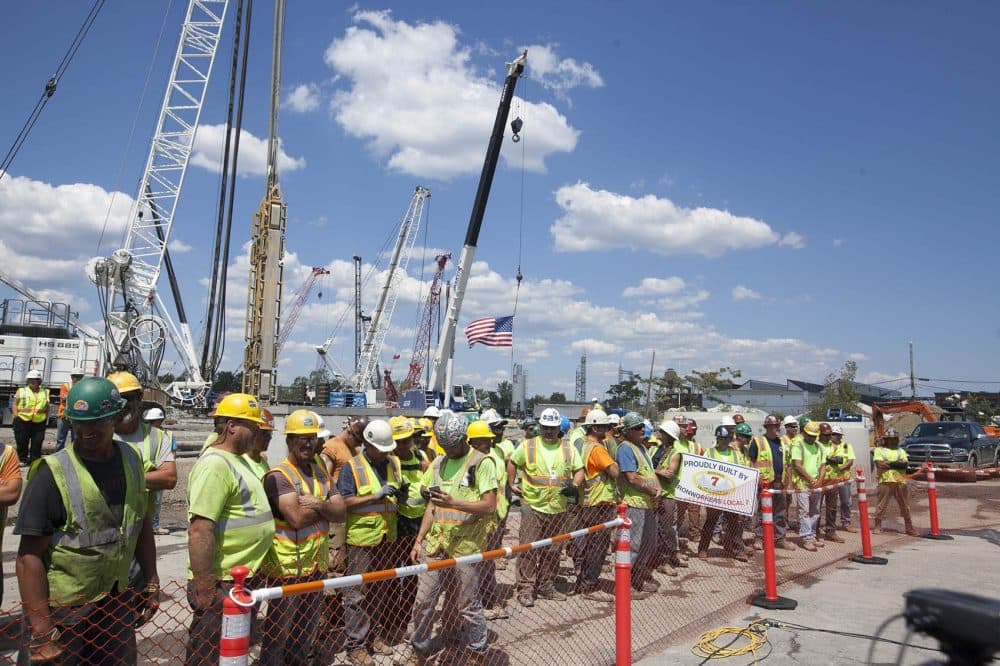 Workers line up before the groundbreaking Thursday. Officials say the casino is creating 8,000 jobs. (Joe Difazio for WBUR)