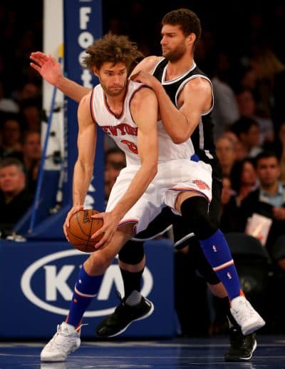 Robin Lopez, #8, formerly with the New York Knicks, says his brother Brook and he purposefully developed opposite skills so they could play at the same time. Brook plays for the Brooklyn Nets. (Elsa/Getty Images)
