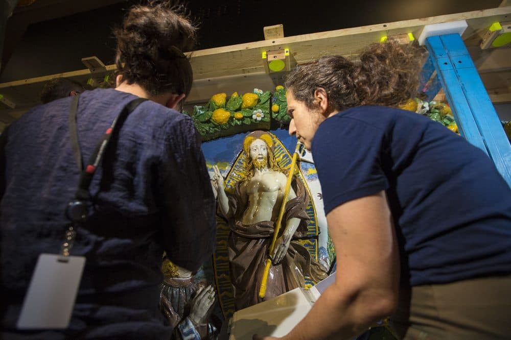 MFA objects conservator Abigail Hykin and Brooklyn Museum conservator Lisa Bruno examine Giovanni della Robbia's &quot;The Resurrection of Christ&quot; after it was uncrated in the exhibition hall. (Jesse Costa/WBUR)