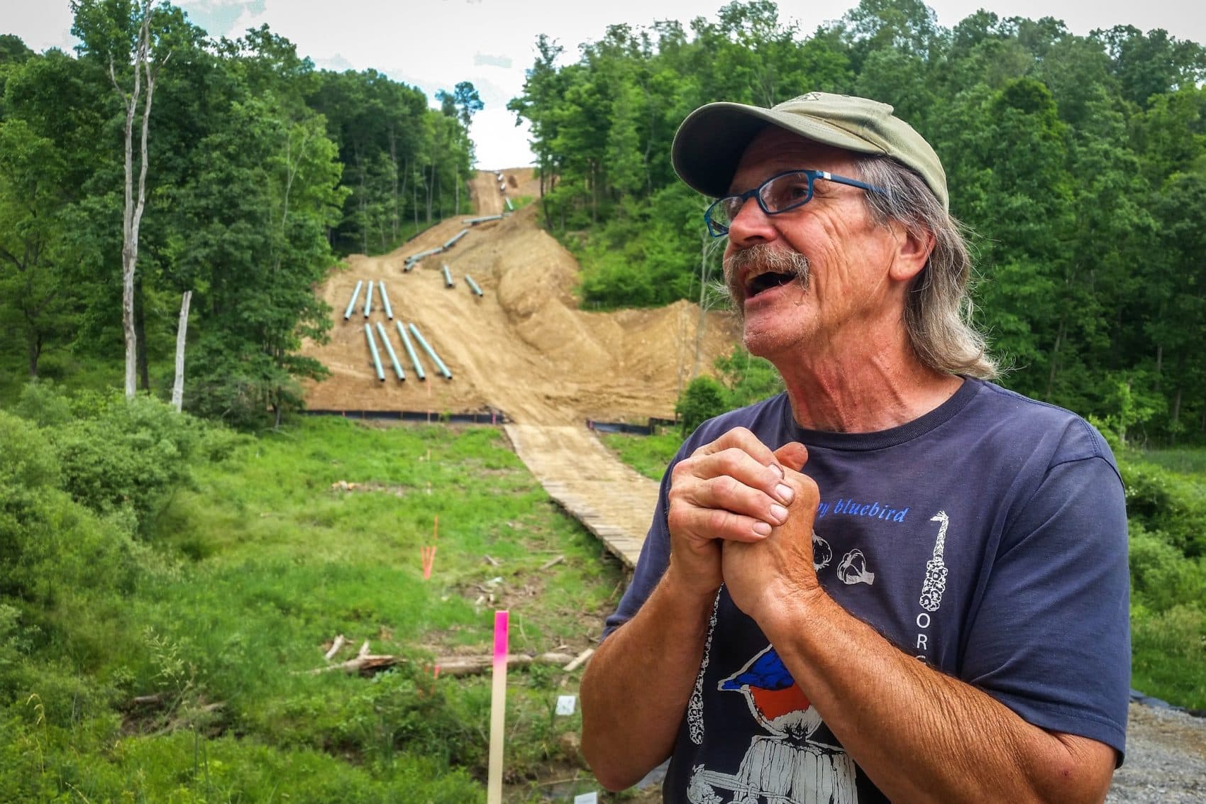 Farmer Mick Luber stands along the southern border of his property in eastern Ohio, where Marathon has begun installing a liquid natural gas pipeline. Luber was able to reach an agreement with another company to reroute its proposed pipeline around his farm. (Julie Grant/Allegheny Front)