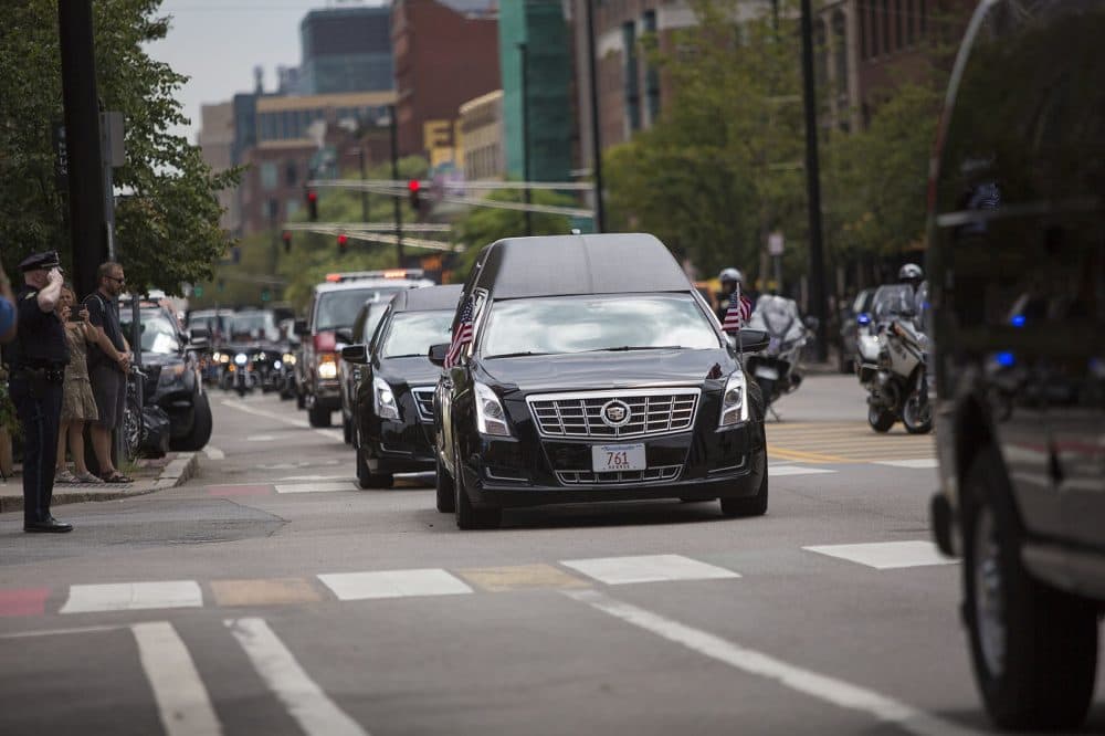The motorcade carrying the remains of Cpl. Ronald Sparks, as well as his family, arrives at Cambridge City Hall Tuesday. (Jesse Costa/WBUR)