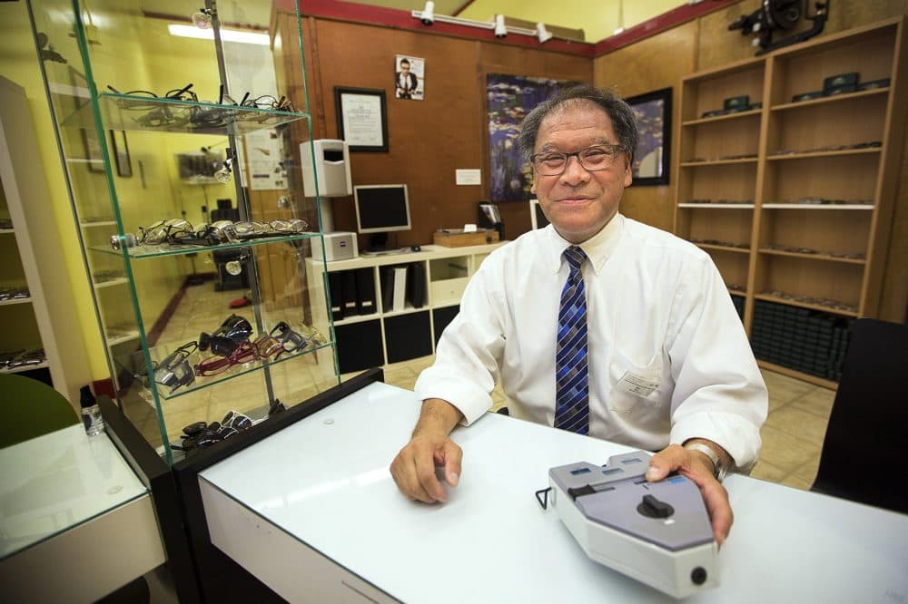 Professor Blair Wong sits in his optical shop, where students at the Benjamin Franklin Institute of Technology learn to become opticians and eye health technology professionals. (Jesse Costa/WBUR)